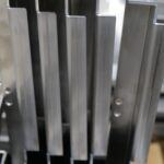 Thin sheet metal component with intricate angles and an grain finish
